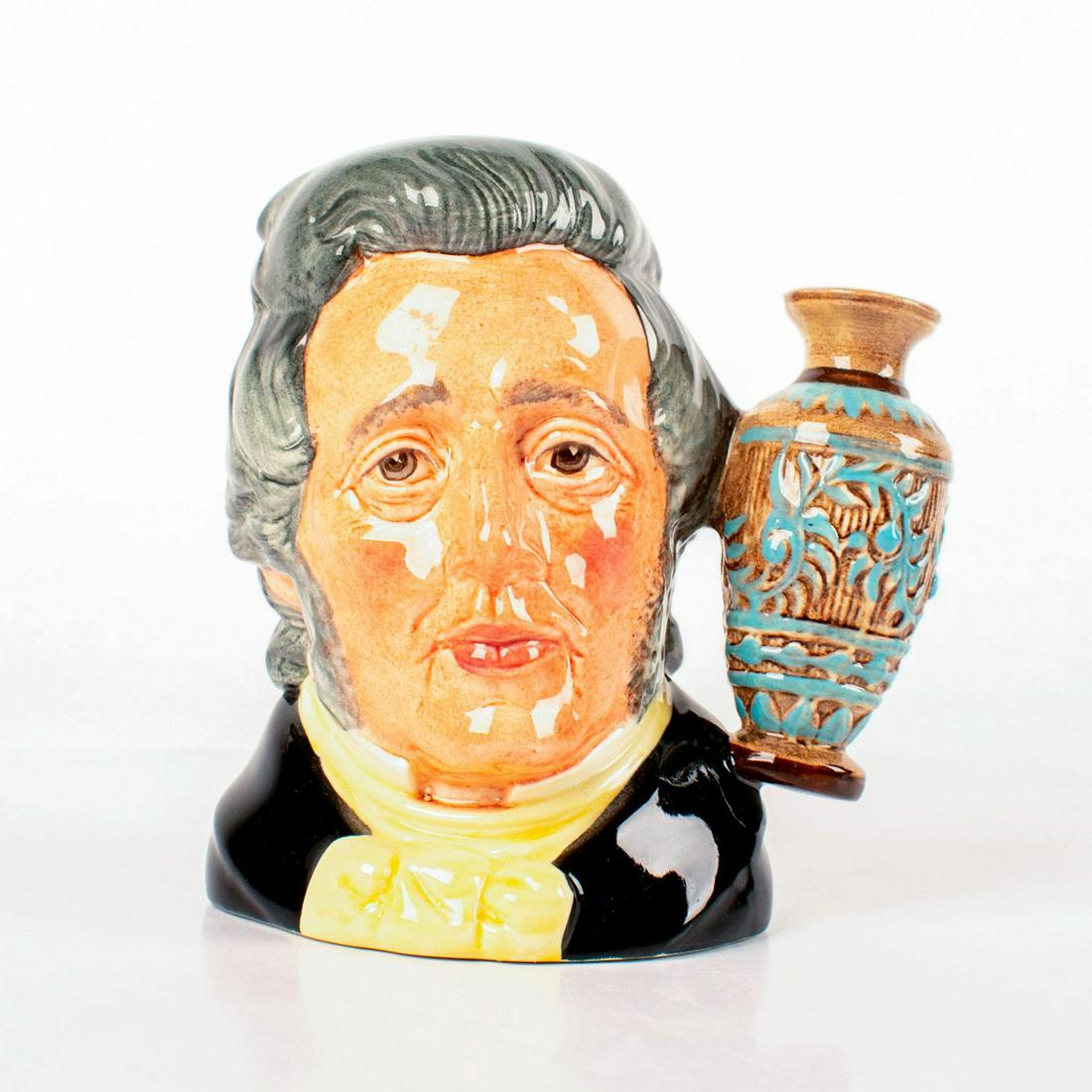 Sir Henry Doulton D6703 - Small - Royal Doulton: Style One, art pottery vase handle. Black coat; yellow cravat; grey hair; brown and blue vase. Royal Doulton backstamp. Artist: Eric Griffiths Issued: 1984 - 1984 Dimensions: 4.5"H Manufacturer: Royal