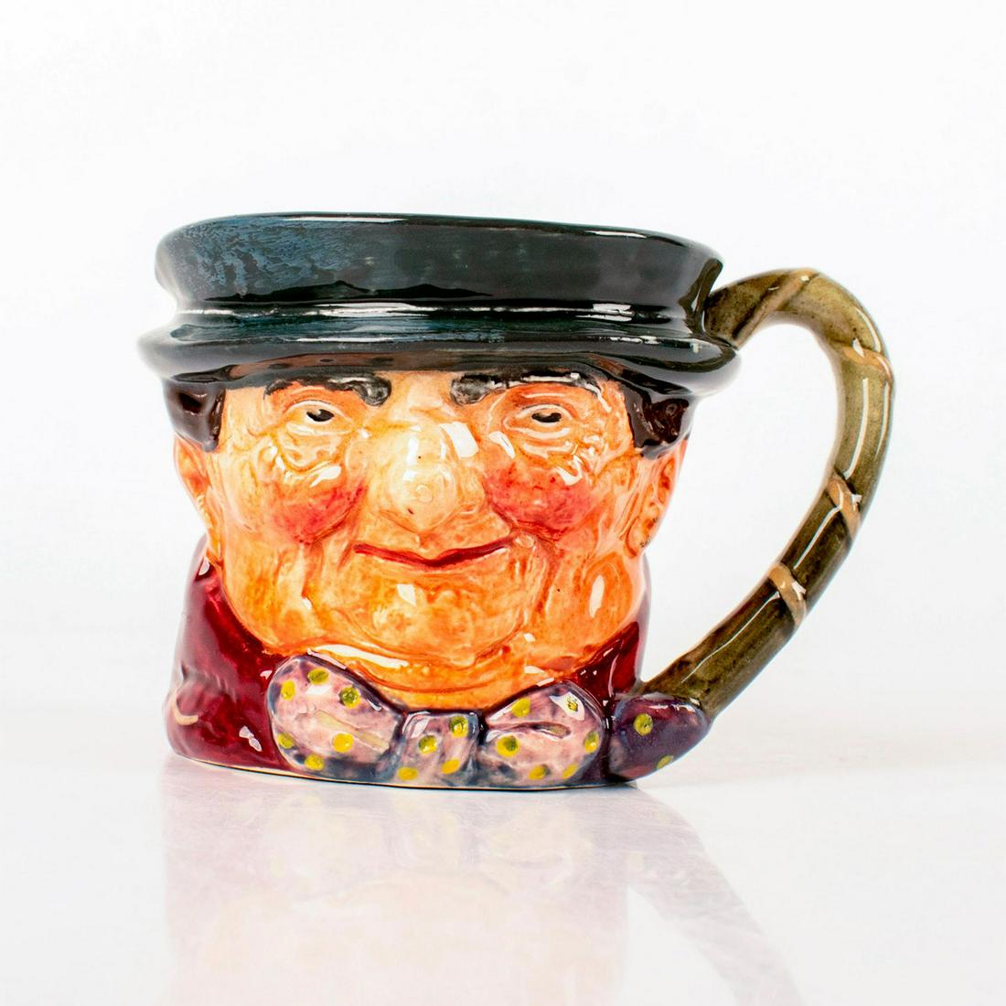 Tony Weller D5530 - Small - Royal Doulton Character Jug: Dark grey hat; maroon coat; grey-white bow with yellow spots. Royal Doulton backstamp. Artist: Leslie Harradine and Harry Fenton Issued: 1936 - 1960 Dimensions: 3.25"H Manufacturer: Royal Doulton Coun