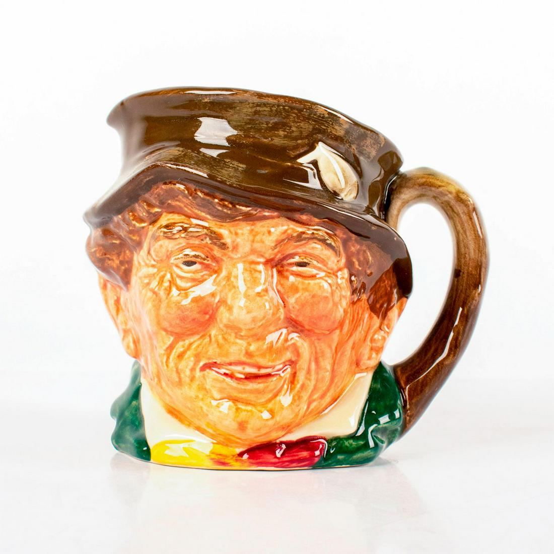Paddy D5768 - Small - Royal Doulton Character Jug: Brown hat; green coat; yellow and red scarf. Royal Doulton backstamp. Artist: Harry Fenton Issued: 1937 - 1960 Dimensions: 3.25"H Manufacturer: Royal Doulton Country of Origin: England