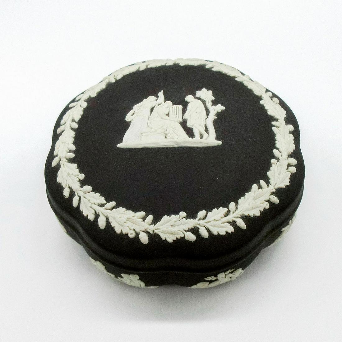 Wedgwood Black Jasperware, Scalloped Box with Lid: Black Jasperware lidded trinket box in a scalloped shape, with Neoclassical figures in white relief. Impressed Wedgwood backstamp. Weight: 14.4 oz #wedgwood #jasperware Issued: 20th c. Dimensions: 2.2
