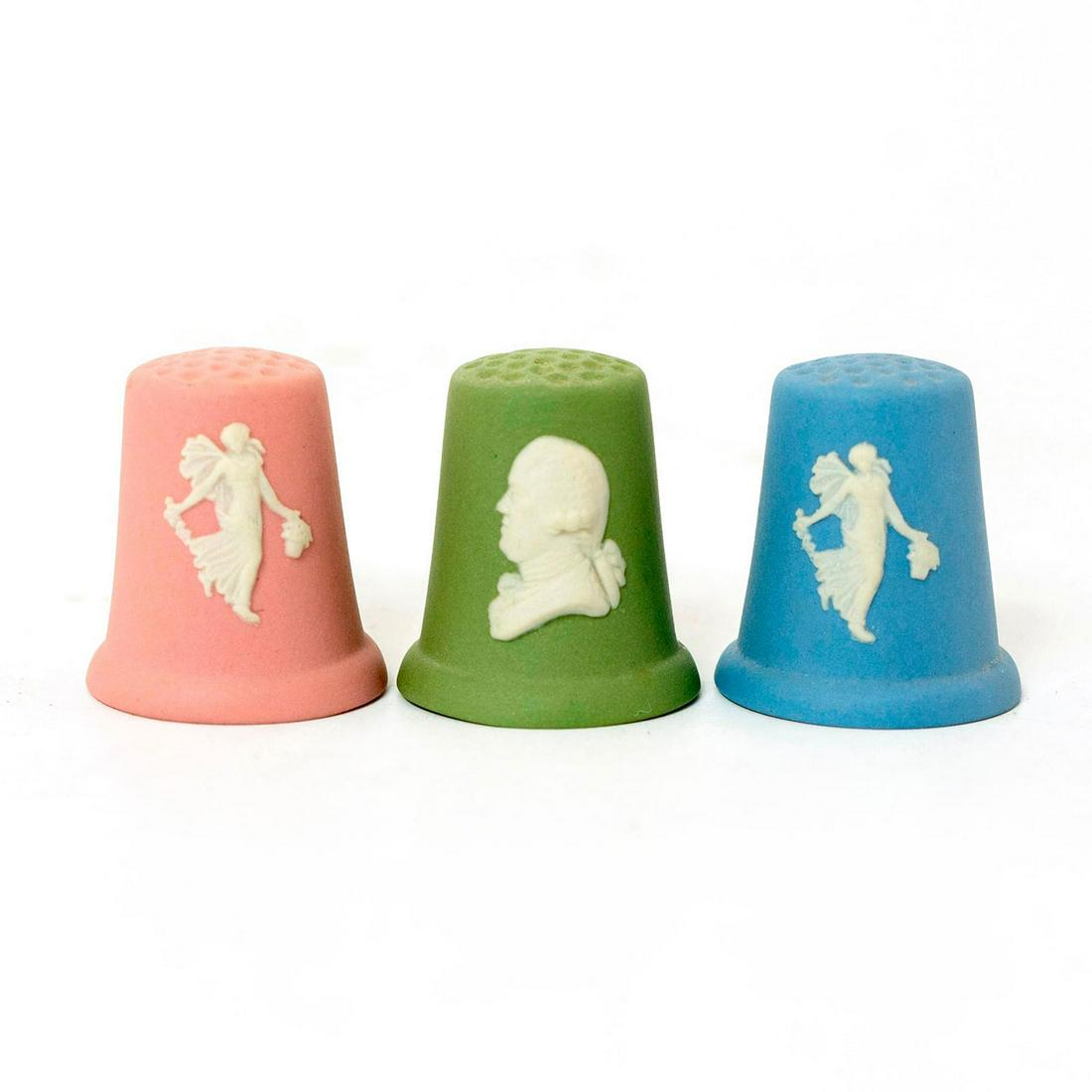 3 Wedgwood Jasperware Thimbles: Blue, green and pink coloration; matte finish; white relief design. Stamped Wedgwood. Issued: 20th c. Dimensions: 1"H Manufacturer: Wedgwood Country of Origin: England
