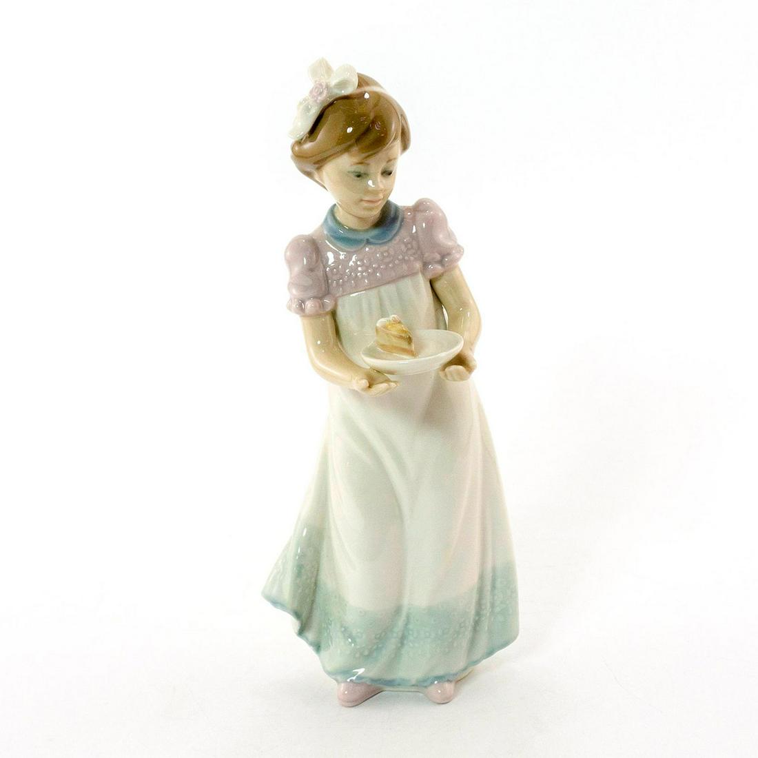 Happy Birthday 1005429 - Lladro Porcelain Figurine: Glazed; Young girl in white dress, holding cake. No box. Lladro backstamp. Artist: Jose Roig Issued: 1987 Dimensions: 7.75"H x 3.25"W Manufacturer: Lladro Country of Origin: Spain