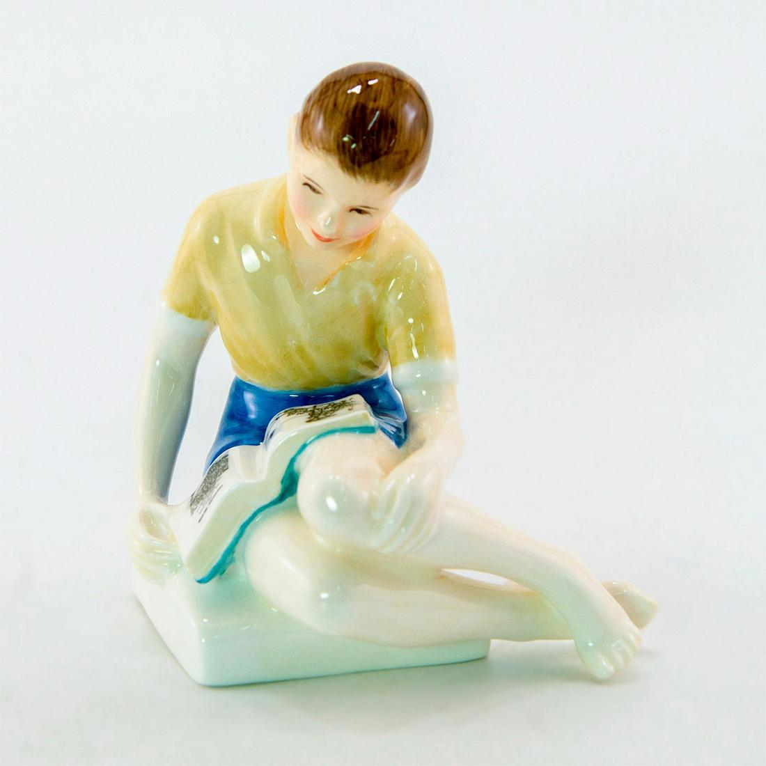 Treasure Island HN2243 - Royal Doulton Figurine: Bone China. Boy seated reading the book 'Treasure Island'. Series: Children's Literature. Royal Doulton backstamp. Artist: Peggy Davies Issued: 1962 - 1975 Dimensions: 4.75"H Manufacturer: Royal Doult