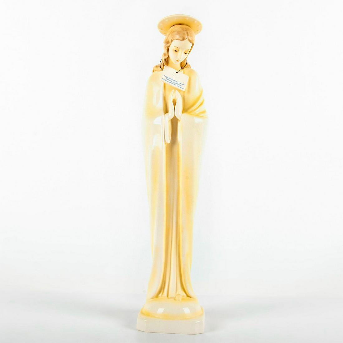 Goebel Hummel Figurine, Madonna with Halo 45/3: 70th anniversary edition of the Virgin Mary praying, with a halo over her head. Cream and yellow coloration. Goebel backstamp. Signed by the artist. Limited edition number 48 of 1935 pieces. Original