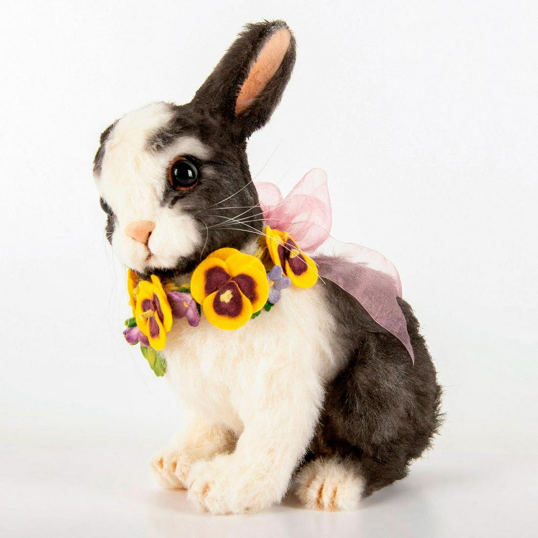 R. John Wright Bunny Doll, Pansy: Alpaca plush bunny with felt details, glass eyes, and circlet of felt pansies and forget-me-nots around neck. The removable head reveals a jacquard-lined candy container. Limited edition number 137 of
