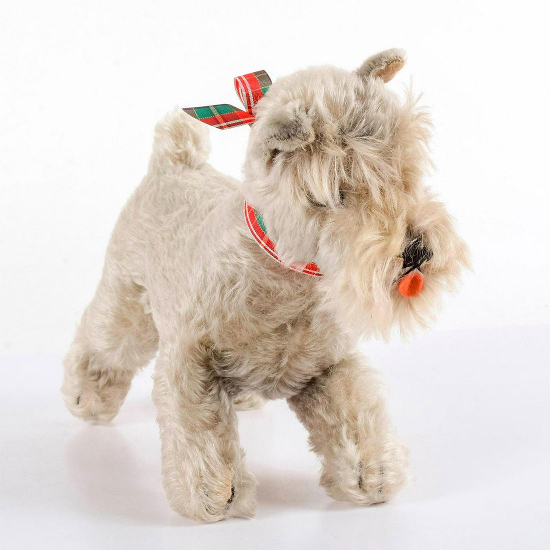 Steiff Mohair Stuffed Animal, Schnauzer: Gray mohair standing schnauzer with his tongue hanging out. Glass eyes and stitched nose. Green and red plaid ribbon around its neck. Button and tag missing. Weight: 6.9oz #steiff #schnauzer Issued: 2
