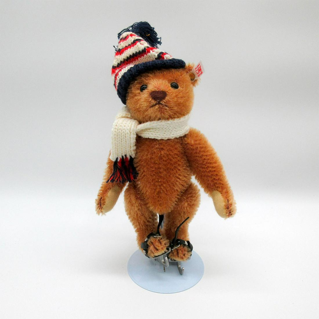 Steiff Ice Skating Teddy Bear, Schlittschuhlaeufer: Brown jointed short mohair teddy with scarf, hat and metal skis. Glass eyes and stitched nose. Button in ear. Limited edition of 3000. Original tag attached. #steiff #teddybear #vintagebears Issued: 