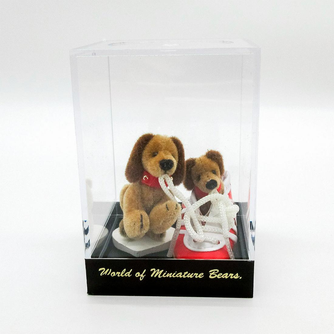 World of Miniature Bears, Toy Collector Dogs, Yummy: Two small brown dogs with a red and white sneaker shoe. One is sitting inside of the shoe. Comes in acrylic display box. #miniaturebears #dogs #dachshund Artist: Becky Wheeler Issued: 20th c. Dimensio