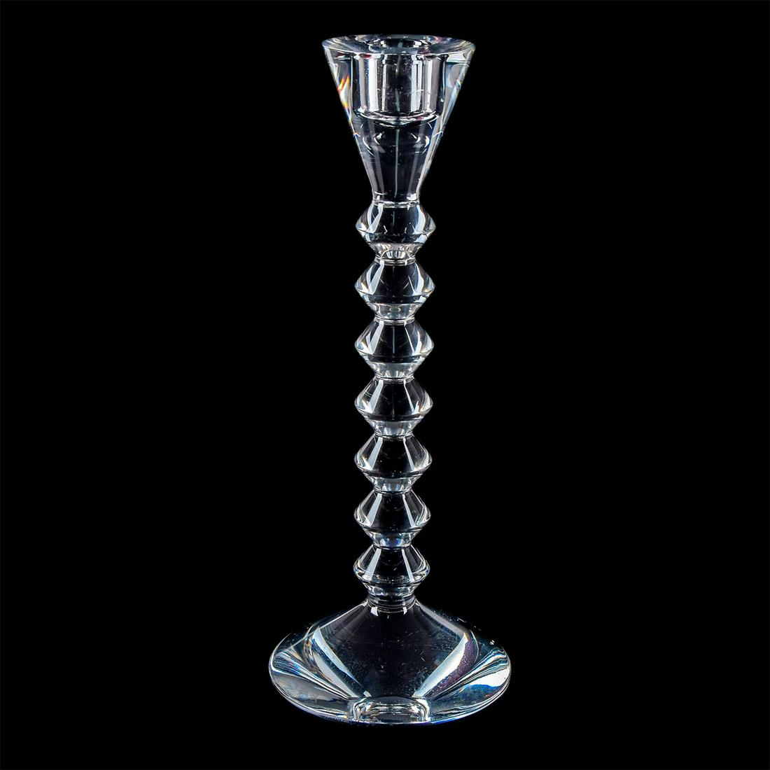 Baccarat Crystal Vega Candlestick: Clear crystal body with a tall geometric stem; 7 stacked diamond-shaped stem with fluted top. Etched Baccarat to base. Includes box. Weight: 1.5 lbs #candlestick Dimensions: 10.5"H Issued: 20th c. Man