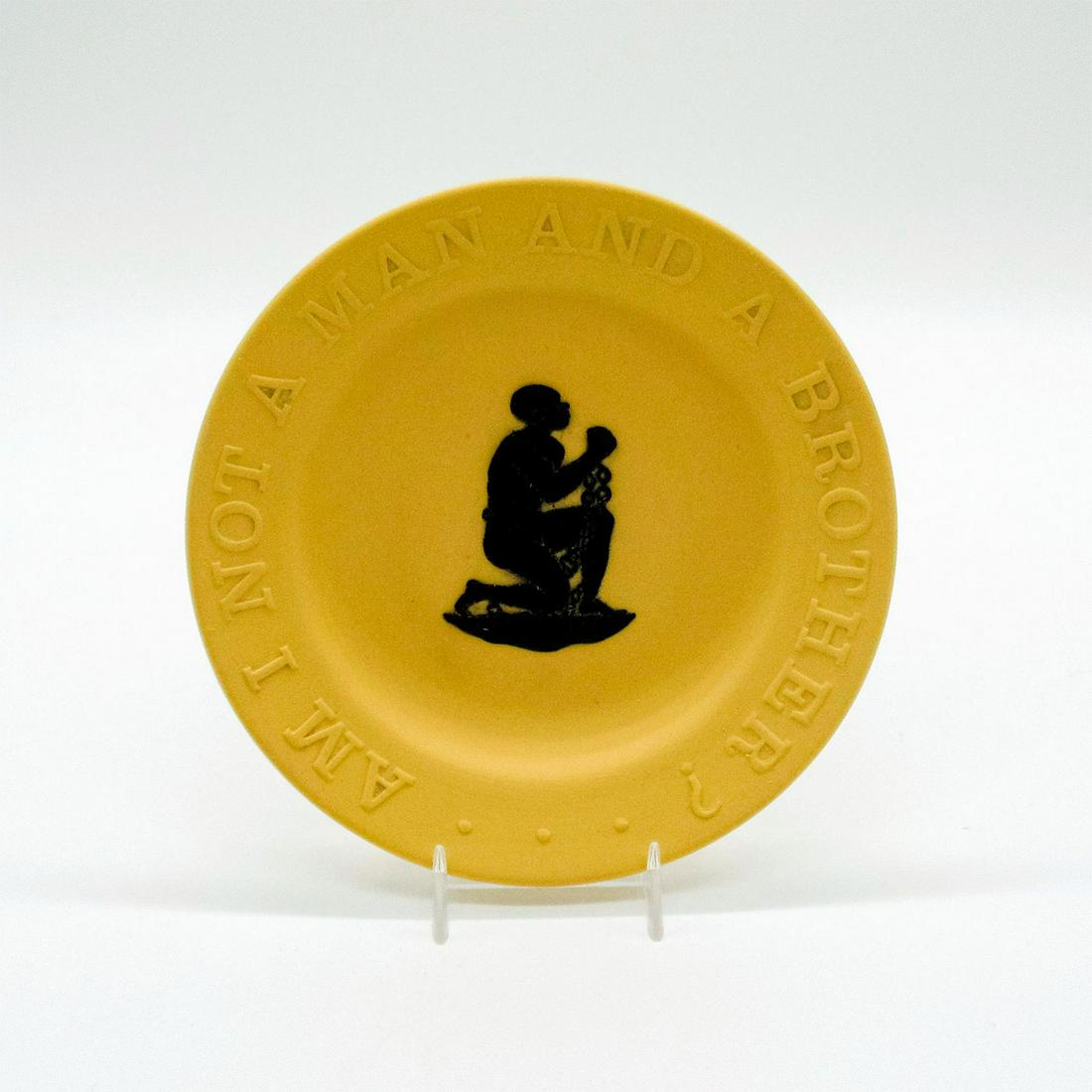 Wedgwood Cane Yellow Jasperware Round Tray: Black decoration in relief of a man in chains; rim reads "Am I not a man and a brother?" Wedgwood impressed on base. Good condition. #wedgwood #jasperware #tray #cane Dimensions: 4.5" dia. Issued: 20t