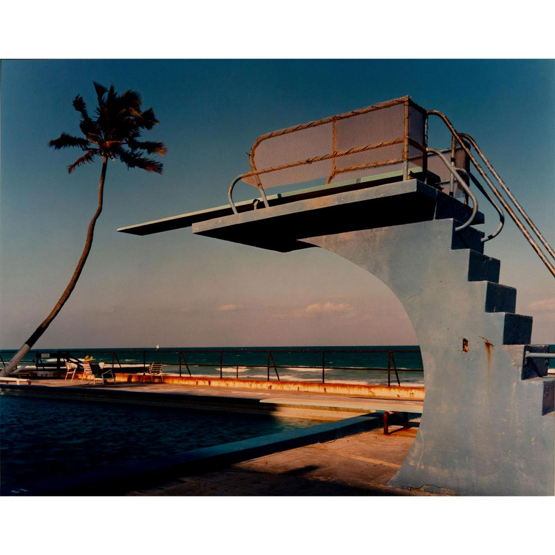 Joel Meyerowitz (American b.1938) Signed, Photograph,: Ektacolor print on paper. Pool diving board and beach. Artist signed and dated on verso. Housed in white matte. Joel Meyerowitz is an American photographer, celebrated as a pioneer of color photograph