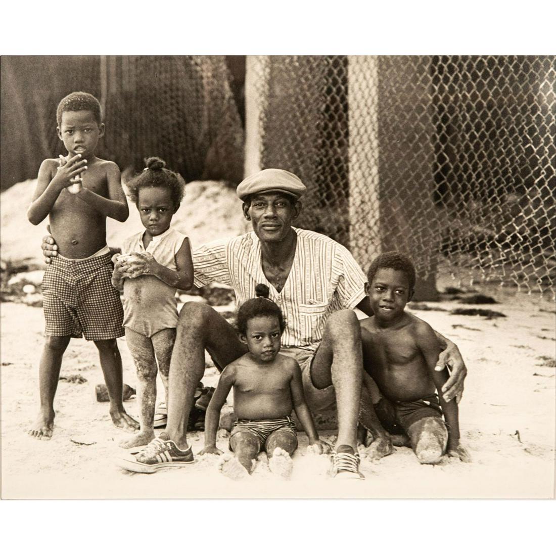 Marcia Walkenstein (American) Photograph on Paper,: Black and white photograph of a man with four children. Housed in black frame with white matte and glass front. Good condition. Sight size: 12.5"H x 15.5"W (31.75cm x 39.37cm). Frame size: 20.25"H x 2