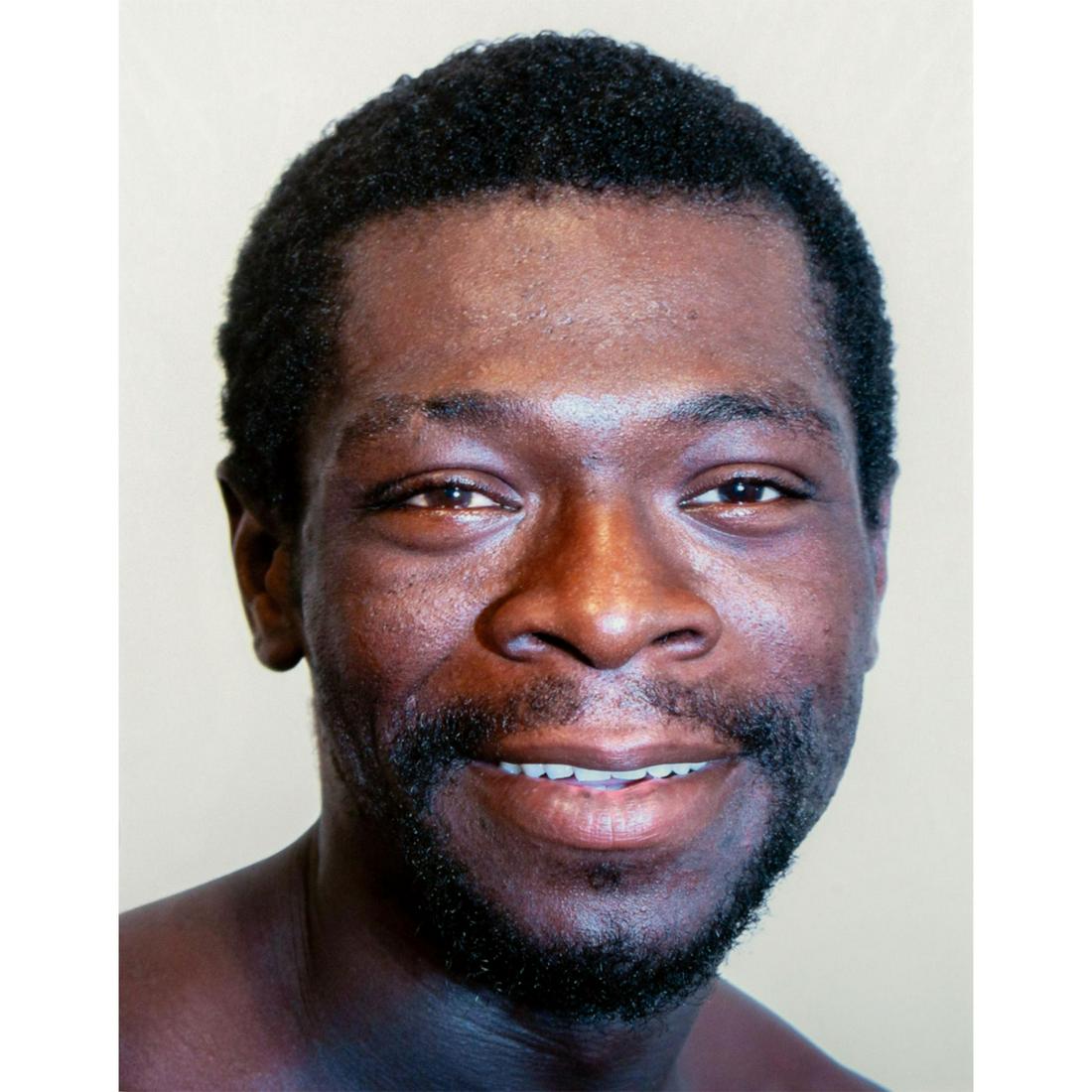 Tim O. Walker (American) Signed, Photograph, Desmond: Archival Ultrachrome ink on paper with white matte. Portrait of a smiling man. Signed lower right, pencil. Titled and numbered I of VI lower left, pencil. From the portfolio Look at Me, is an ongoing 