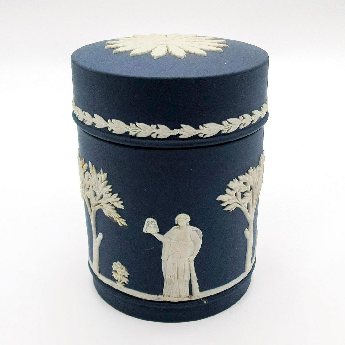 Wedgwood Jasperware Lidded Jar: Dark blue with white relief decorations; Floral patterns decorate the lid. Wedgwood backstamp. Age related wear. Weight: 1 lb 1.3 oz #wedgwood #jasperware #jar Issued: 20th c. Dimensions: 4.25"H x 3"
