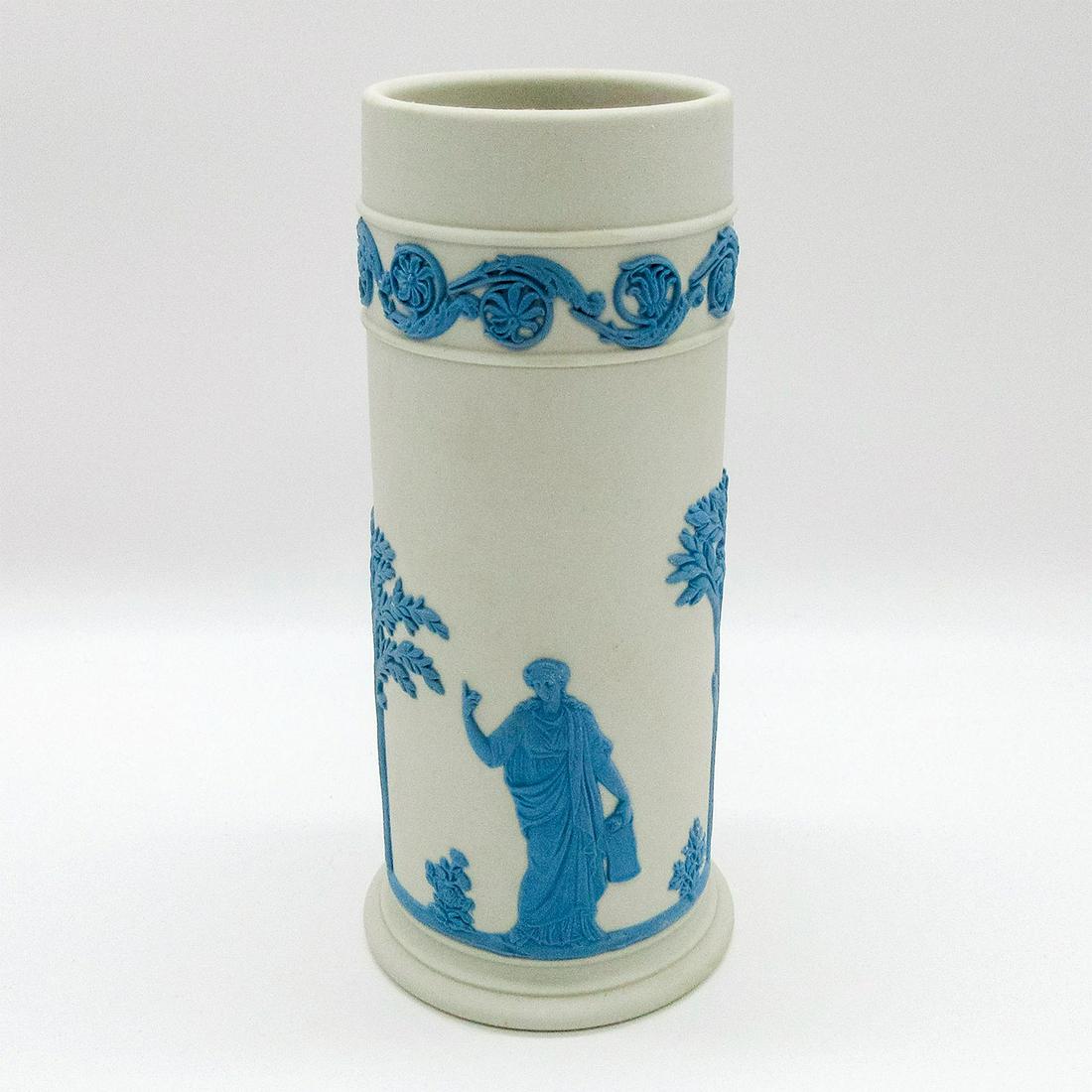 Wedgwood Pale Blue On Cream Jasperware Vase: Cylindrical form spill vase; cream colored matte ground with pale blue Neoclassical designs encircling body. Wedgwood impressed backstamp. #vase #decor Issued: 20th c. Dimensions: 6.25"H Manufacturer:
