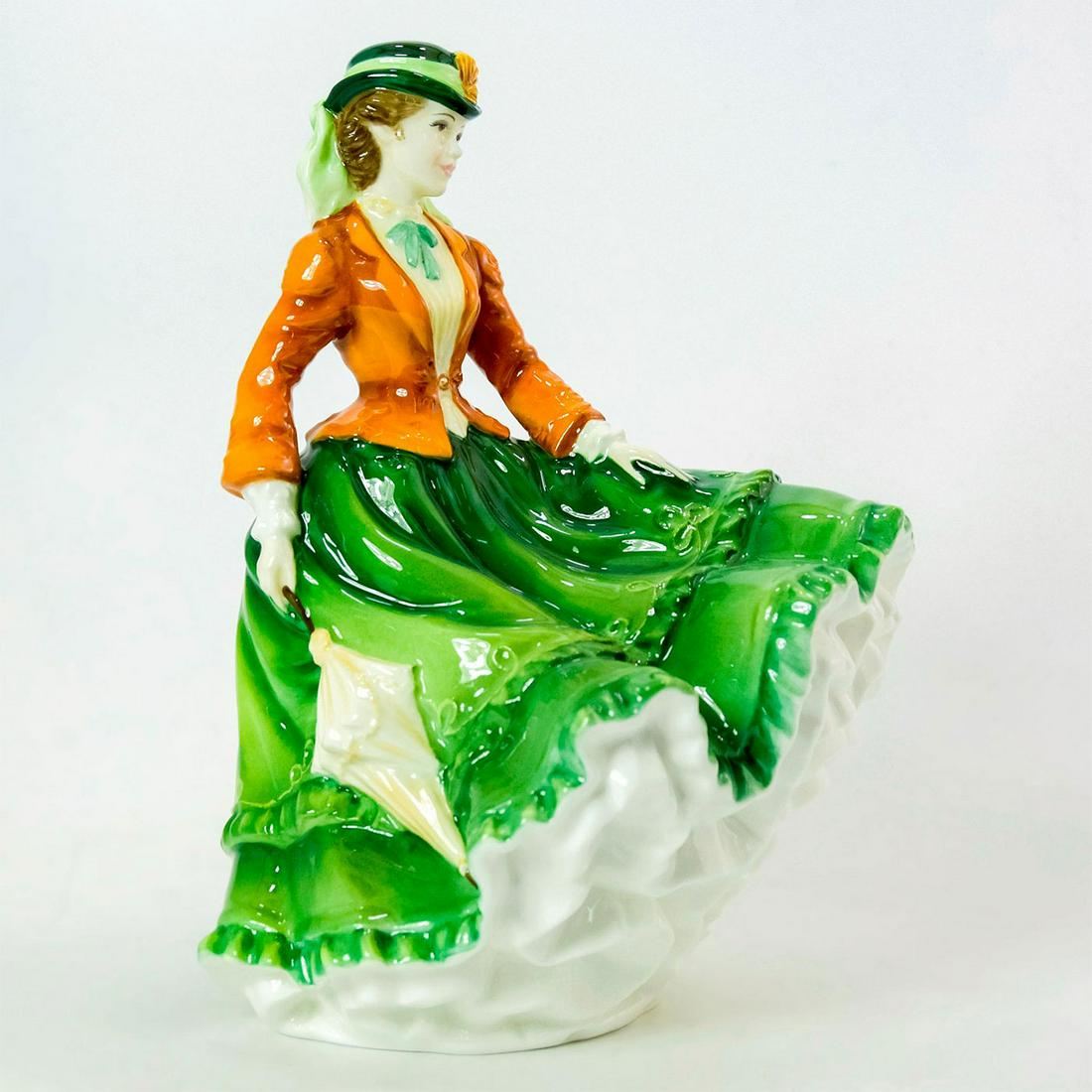 Nicole HN4112 - Royal Doulton Figurine: Bone China. She wears a green skirt, cream blouse, and orange jacket. Series: RDICC. Royal Doulton backstamp. Weight: 1 lb 5.9 oz Artist: Nada Pedley Issued: 1999 - 1999 Dimensions: 8"H Manufacturer: 