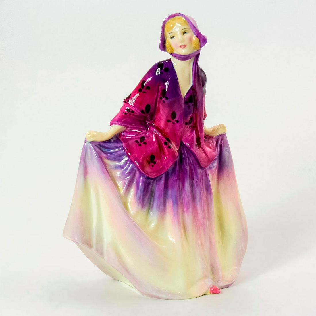 Sweet Anne HN1496 - Royal Doulton Figurine: Bone China. She wears a purple and yellow skirt with a matching bonnet and fuchsia jacket. Series: Harradine Classics. Royal Doulton backstamp. Weight: 9.6 oz Artist: Leslie Harradine Issued: 1932 - 1