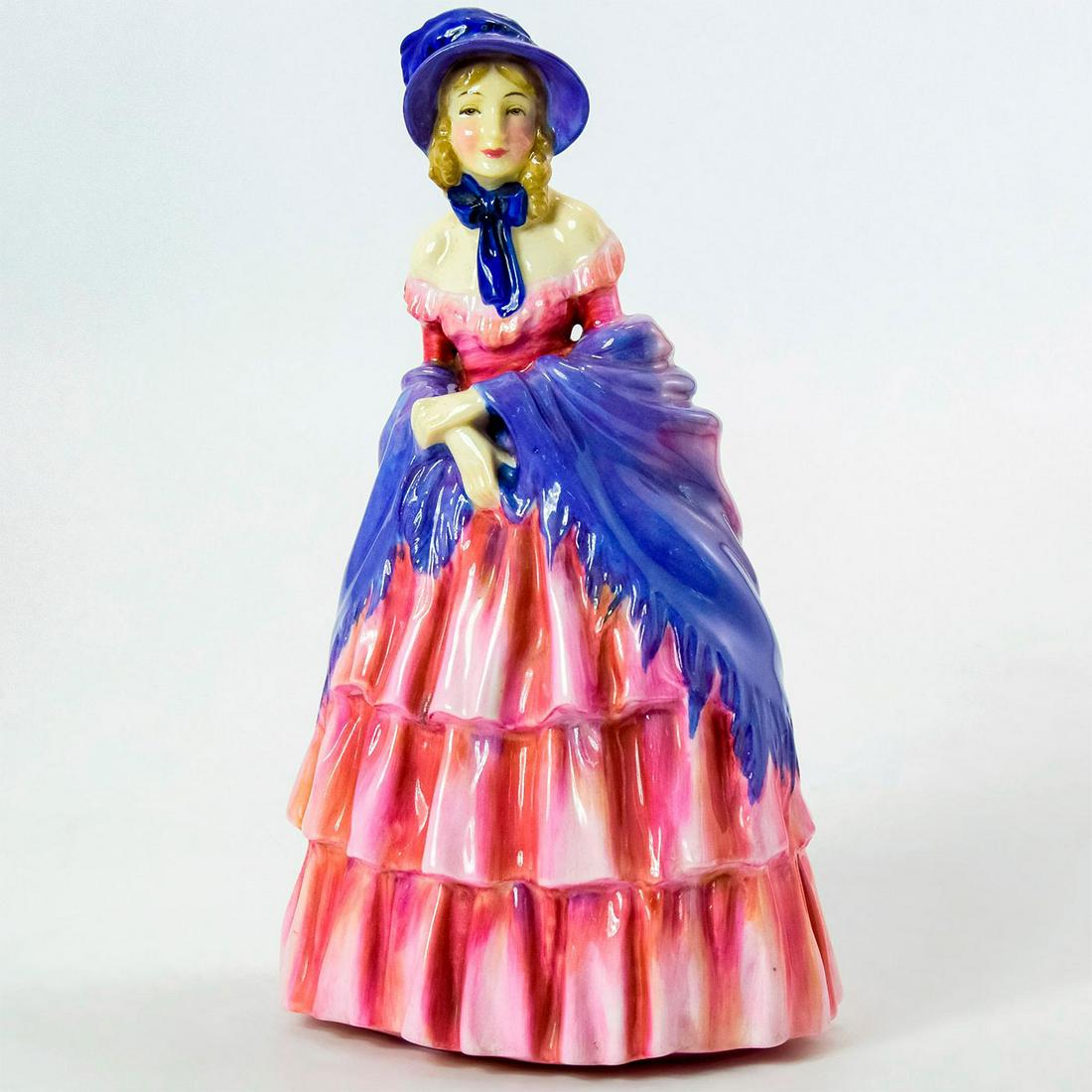 Victorian Lady HN728 - Royal Doulton Figurine: Lady in a pink ruffled dress, a purple shawl, and bonnet. Series: Harradine Classics. Royal Doulton backstamp. Weight: 14.2 oz Artist: Leslie Harradine Issued: 1925 - 1952 Dimensions: 7.75"H Manufactu