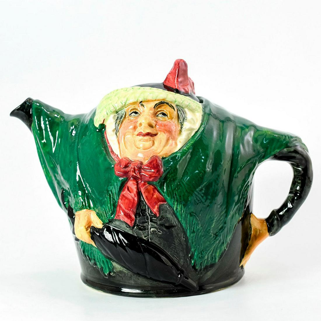 Sairey Gamp D6015 - Teapot - Royal Doulton: Dark green coat, red bow, black hat. Based off character from Charles Dickens 1843 novel "Martin Chuzzlewit." Royal Doulton backstamp. Good condition. #royaldoulton #teapot #saireygamp #charlesdickens
