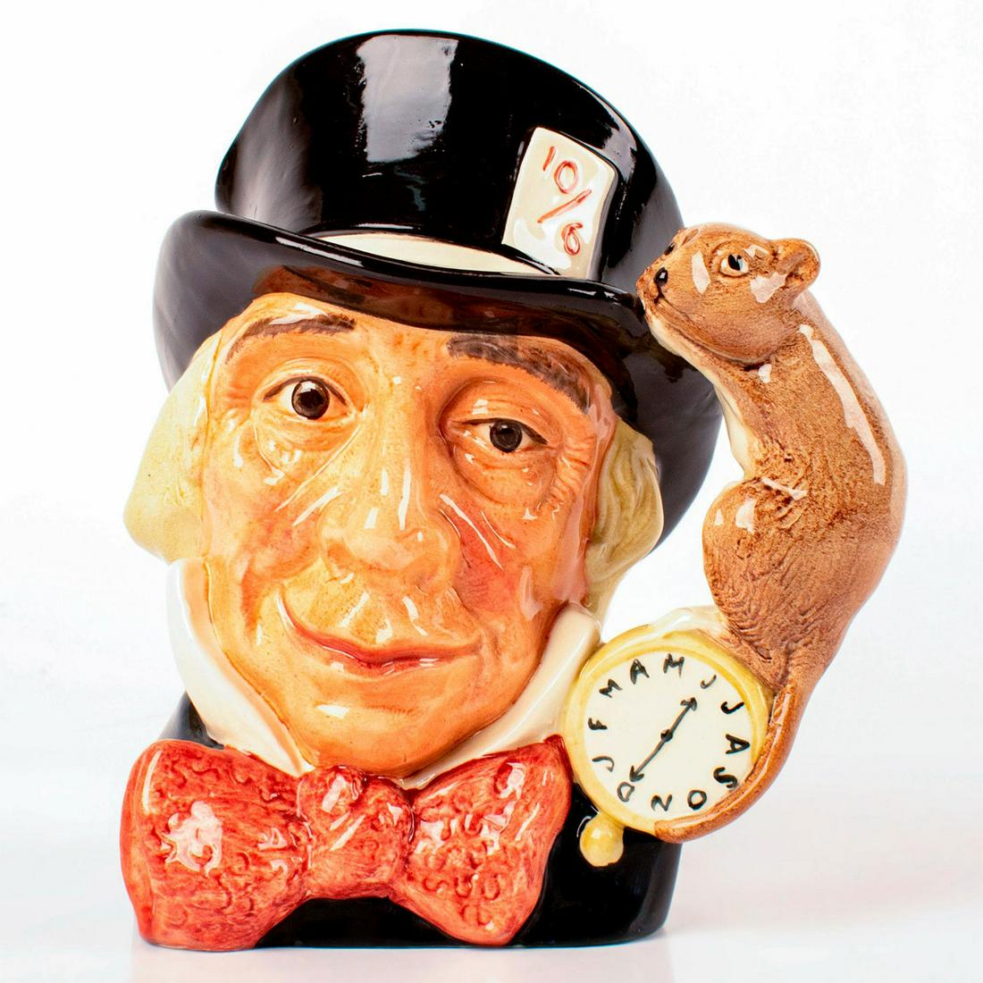 Mad Hatter D6598 - Large - Royal Doulton Character Jug: Variation One. Black hat, dark red bow tie. A character from Lewis Carroll's "Alice's Adventures in Wonderland," the Mad Hatter wears a watch that tells time in months, rather than in hours. Series: A