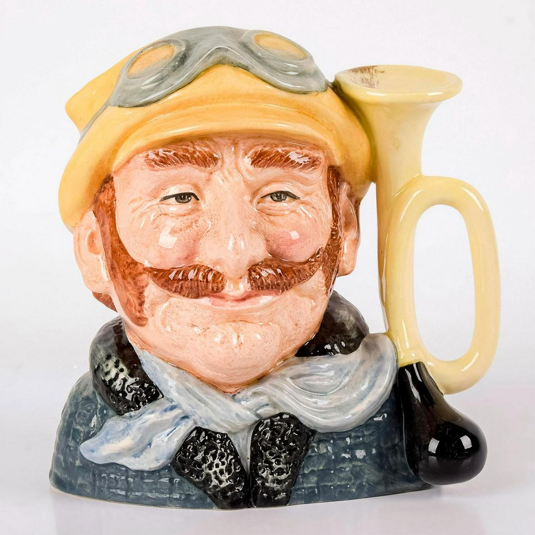 Veteran Motorist D6633 - Large - Royal Doulton: Yellow hat, green coat, white scarf. Royal Doulton backstamp. Artist: David B. Biggs Issued: 1973 - 1983 Dimensions: 7.5"H Manufacturer: Royal Doulton Country of Origin: England