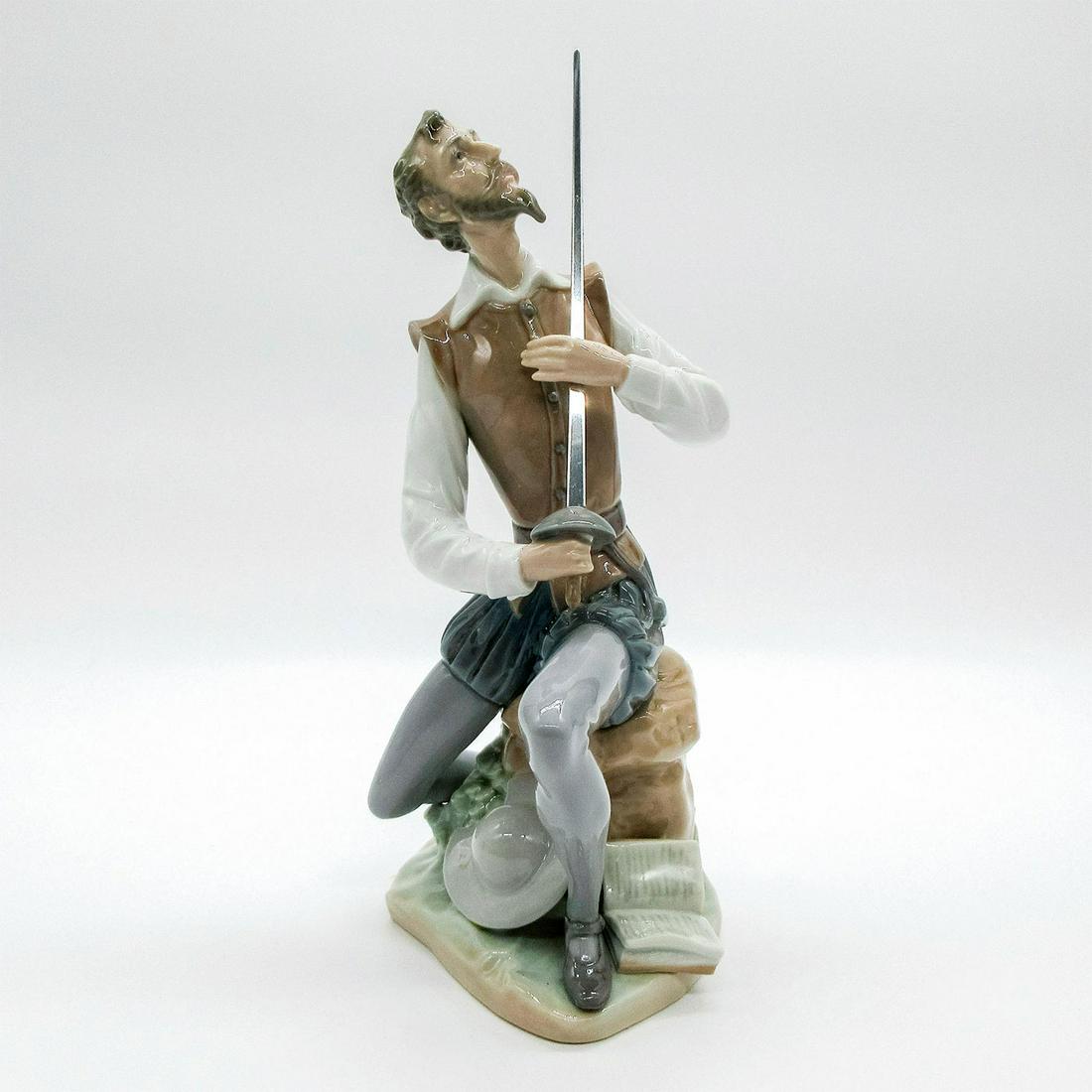 Oration 1005357 - Lladro Porcelain Figurine: Glazed finish; Don Quixote holding a sword. Lladro backstamp. Box not included. Glue residue on the sword. Overall good condition. Artist: Salvador Furio Issued: 1986 - Dimensions: 9"H Manufacturer: L
