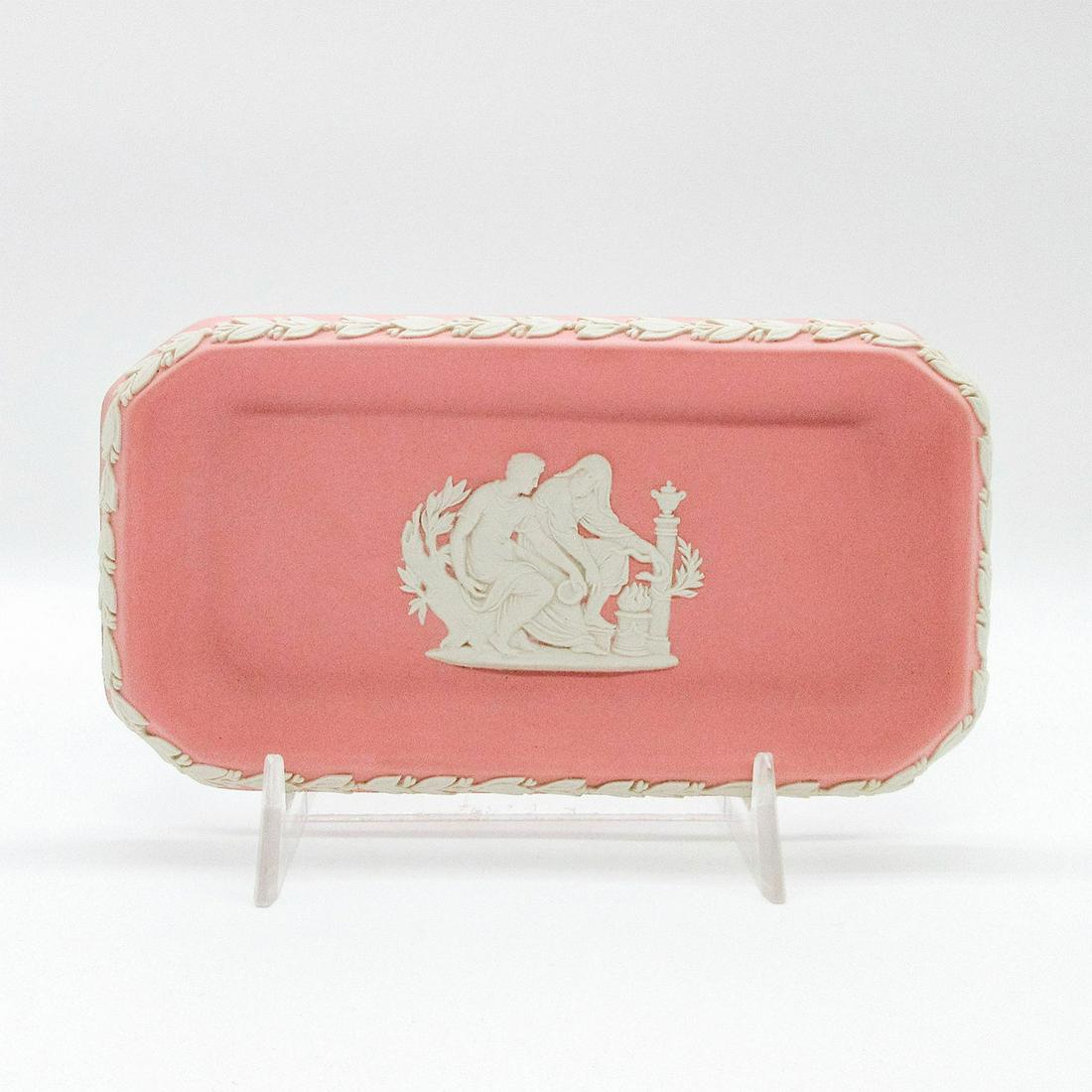 Wedgwood Pink Jasperware Trinket Tray: Rectangular shaped light pink tray with central white relief Neoclassical scene; foliate borders. Wedgwood impressed backstamp. #tray #trinket Issued: 20th c. Dimensions: 6"L Manufacturer: Wedgwood Co