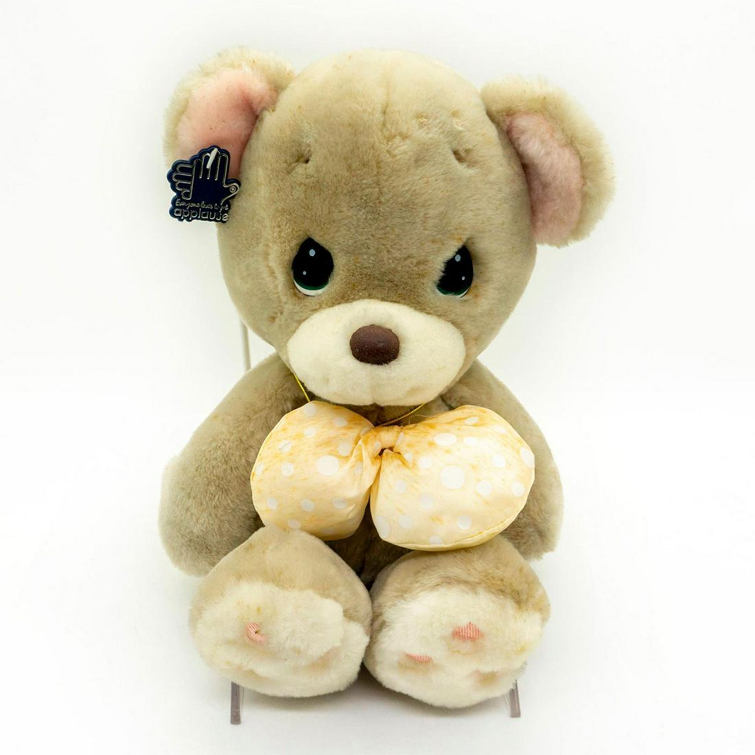Applause Vintage Teddy Bear, Precious Moments 4560: White polka dot bow. Pink heart-shaped locket on goldtone cord. Pink stitching on paws. Manufacturer tag on back. Age related wear. Minor staining throughout. #teddybear #plush #stuffedanimal #vintage
