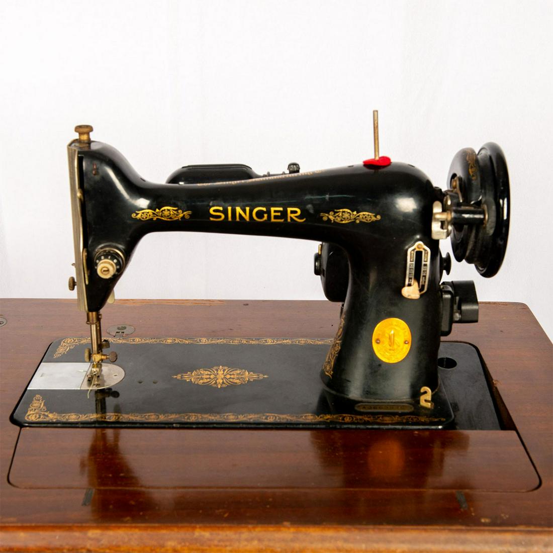 Vintage Singer Sewing Machine and Sewing Table,: Black Singer AJ-66 sewing machine and original wooden sewing table. Singer Buttonhole Attachment 121795 and instructions included. Foot pedal, various spare parts, bobbins, and machine belts are inclu