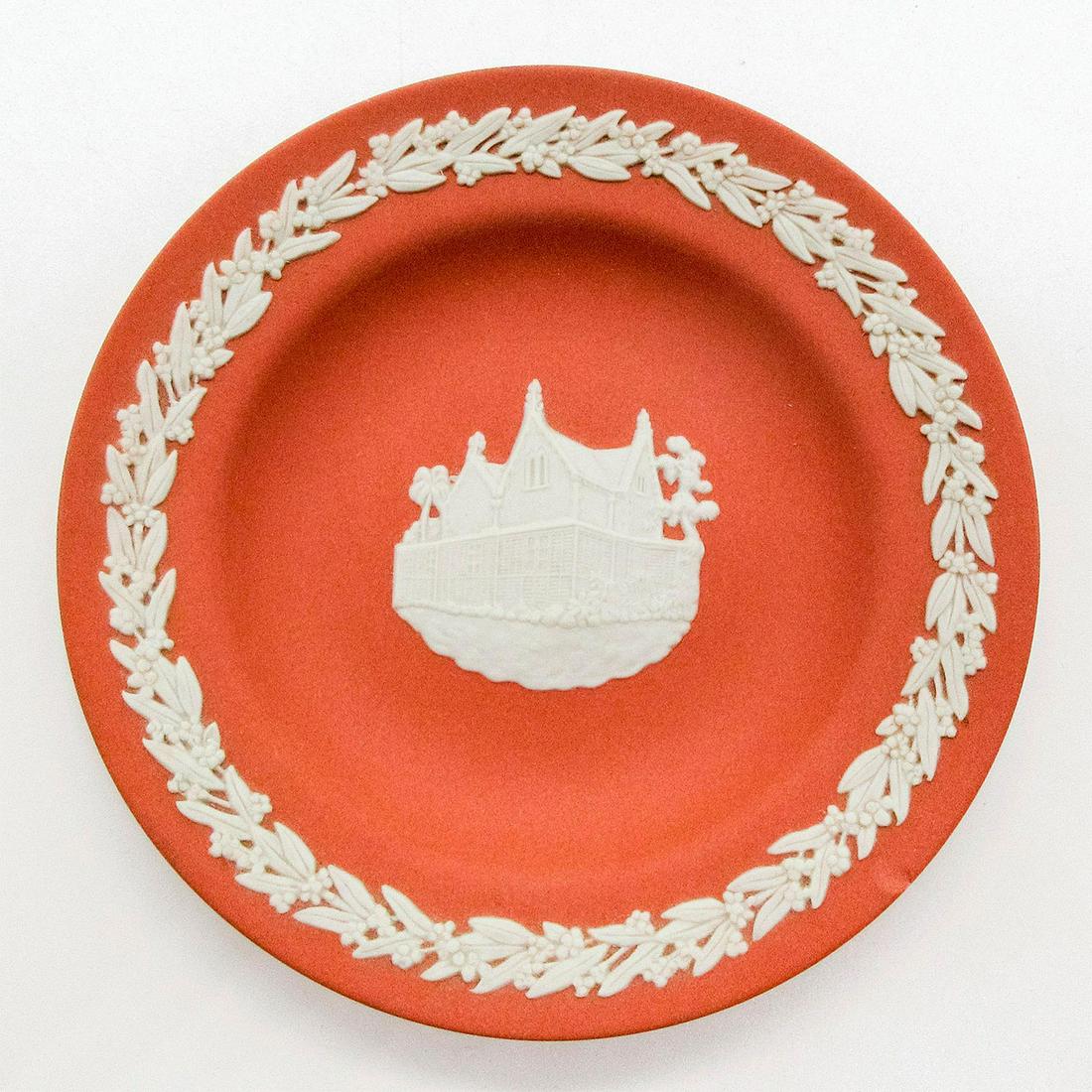 Wedgwood Terracotta Jasperware, Government House Round: Orange colored small plate; "Government House, Darwin, Australia" design in white sprigged decoration. Wedgwood impressed on back. #wedgwood #Australia Issued: 20th c. Dimensions: 0.5"H x 4.5" dia Man
