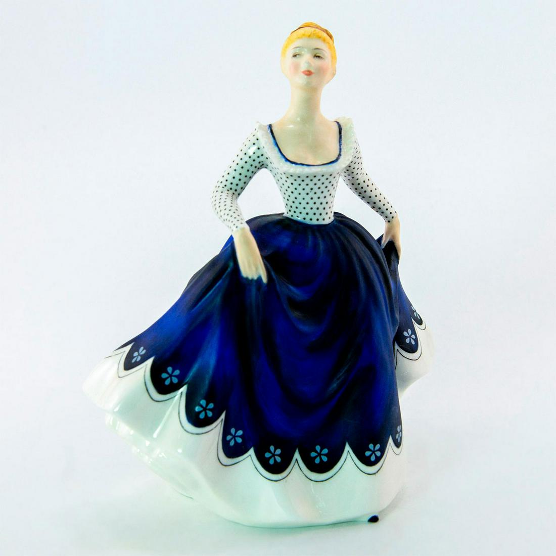 Lisa HN2310 - Royal Doulton Figurine: Bone China. She wears a black and white polka dot top and matte blue skirt. Series: Peggy Davies Classic. Royal Doulton backstamp. Artist: Peggy Davies Issued: 1969 - 1982 Dimensions: 7.25"H Manufactu