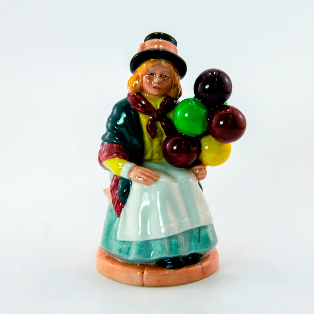 Balloon Girl HN2818 - Royal Doulton Figurine: Girl sits anxiously awaiting her next customer, wearing a grey shawl and black hat. Series: Balloon Characters. Royal Doulton backstamp. Artist: William K. Harper Issued: 1982 - 1977 Dimensions: 6.5"H