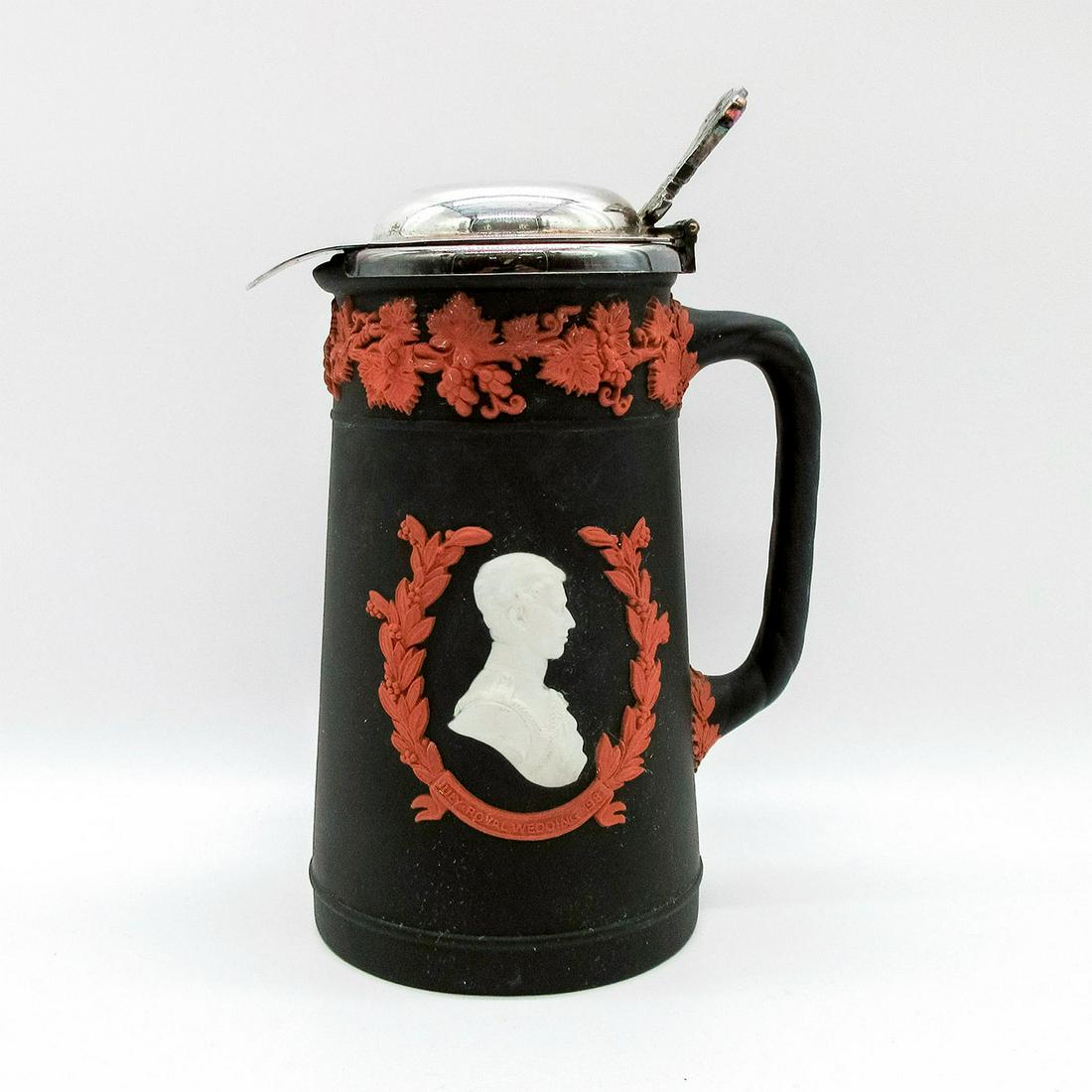 Wedgwood Tricolor Jasperware Lidded Jug: Royal Wedding Collection 1981. Terracotta on black jasperware with white relief portraits of Prince Charles and Diana. Silvertone lid. Wedgwood impressed backstamp. #jug #Royalty Issued: 20th c. Dimen