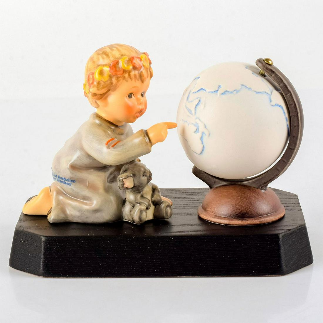 Australian Wanderer Hum2064 - Goebel Hummel Figurine: Little girl in gray dress with a koala bear and red and yellow flowers pointing at a globe. With wooden display. Certificate of Authenticity. Goebel backstamp. Hummel impressed in the side. Original b
