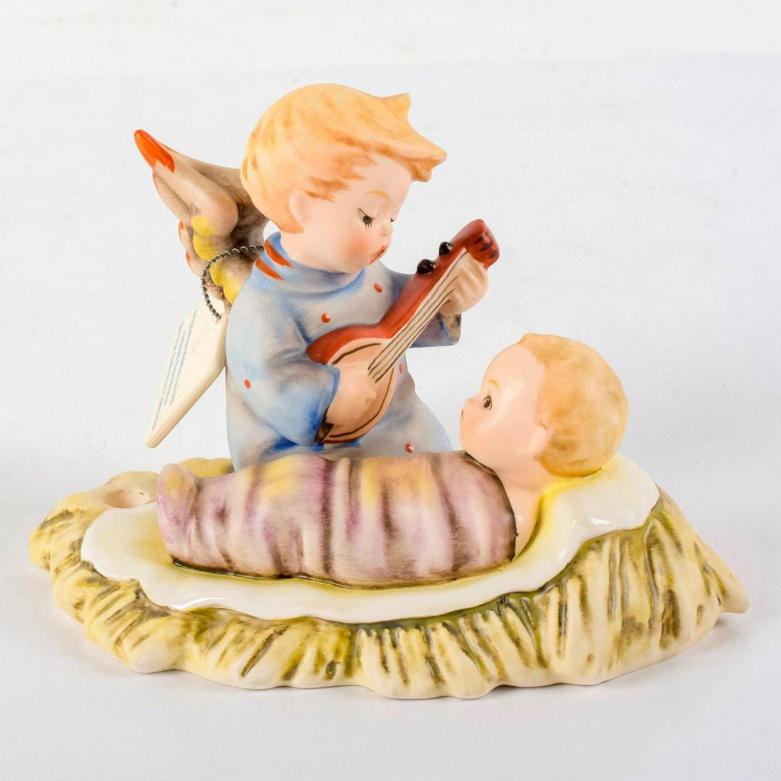 Lullaby Hum24/I - Goebel Hummel Figurine: Limited edition figurine of little angel in blue dress singing to a baby wrapped in purple blankets. Small candle holder on the side. 70th anniversary limited edition number 1744 of 1935. Goebel backs