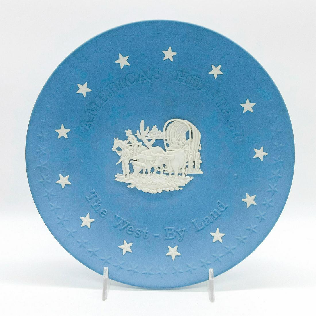 Wedgwood Jasperware Plate, America's Heritage: The West- By Land. Pale blue ground; central scene in white relief. Wedgwood impressed backstamp. #plate Issued: 20th c. Dimensions: 8.25" dia Manufacturer: Wedgwood Country of Origin: England