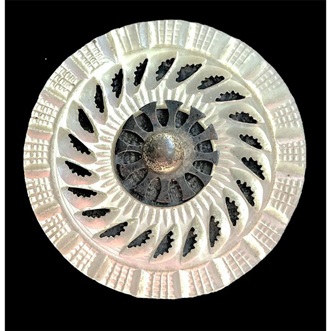 AN 18TH CENTURY STEEL AND PEARL BUTTON: 1 Large carved 18th century pearl with blued steel. This nice large 18th century example shows an outer carved border, an inner border which is openwork in the pearl and a blued steel center. Issued: