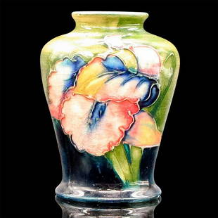 Moorcroft Pottery Miniature Vase, Iris: Hand painted deep blue and green ground decorated in colorful hues of pinks, blues, and white petals with green foliage. Moorcroft, Potter to H.M. the Queen, Made in England, William Moorcroft