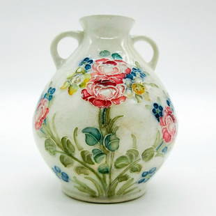 Macintyre Burslem Moorcroft Miniature Double Handled Vase: Roses and Forget Me Nots. Ovoid body with fluted rim; tubelined design of pink rose and yellow narcissus flowers. Macintyre Burslem backstamp. #Moorcroft #Burslem Issued: 20th c. Dimensions: 2.75"H