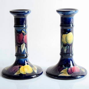 William Moorcroft Wisteria pair of Candlesticks: A lovely pair of Wisteria pattern candlesticks in lavender and yellows. With marks to base and signature. #wisteria #floweringplants Issued: c. 1925 Dimensions: 6.75"H Manufacturer: Moorcroft