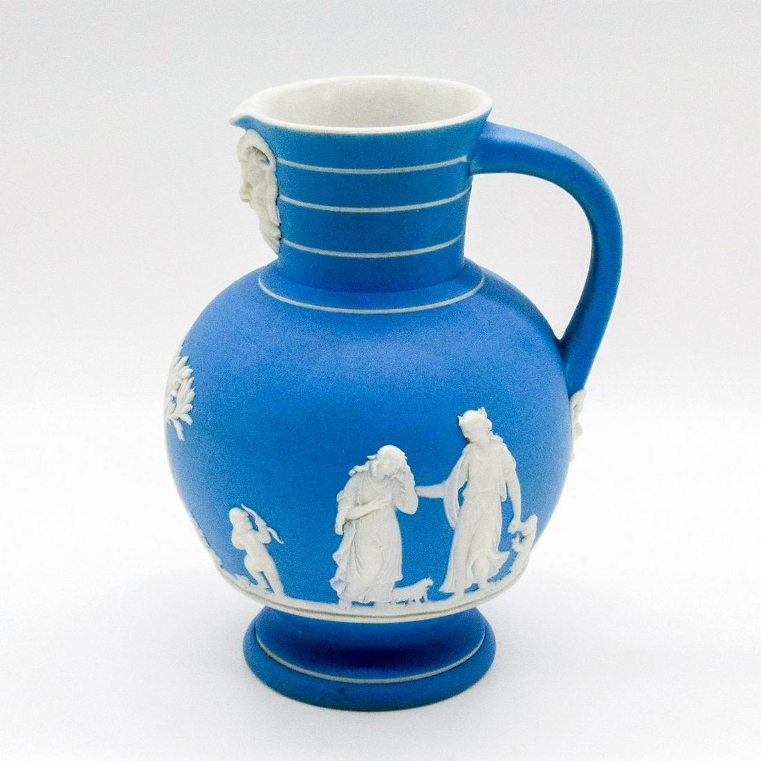 Rare Wedgwood Jasperware Pale Blue Doric Pitcher: Single handle; glazed interior. White relief Grecian-inspired decorations. Wedgwood and Doric impressed on base. Age related wear; minor cracks throughout. #wedgwood #jasperware #pitcher #doric Issued