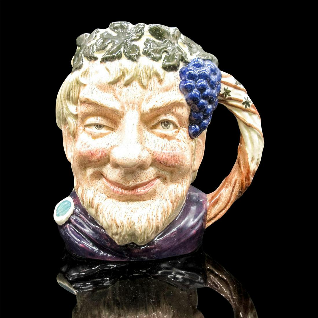 Bacchus D6499 - Large - Royal Doulton Character Jug: Glazed, hand painted ceramic. Bacchus is in a maroon robes, with green leaves and purple grapes adorn his head. The handle is a grapevine. Royal Doulton backstamp. Artist: Max Henk Issued: 1959 - 1991