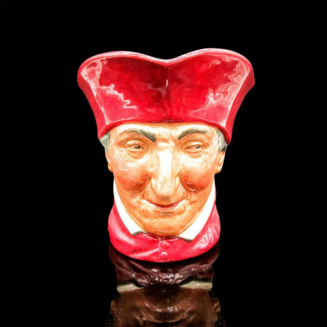 Cardinal D5614 - Large, - Royal Doulton Character Jug: Glazed, hand painted ceramic. The Cardinal has grey hair, and is dressed in a scarlet robe. The handle of the jug is painted purple. Royal Doulton backstamp. Artist: Charles Noke Issued: 1936 - 1960 D