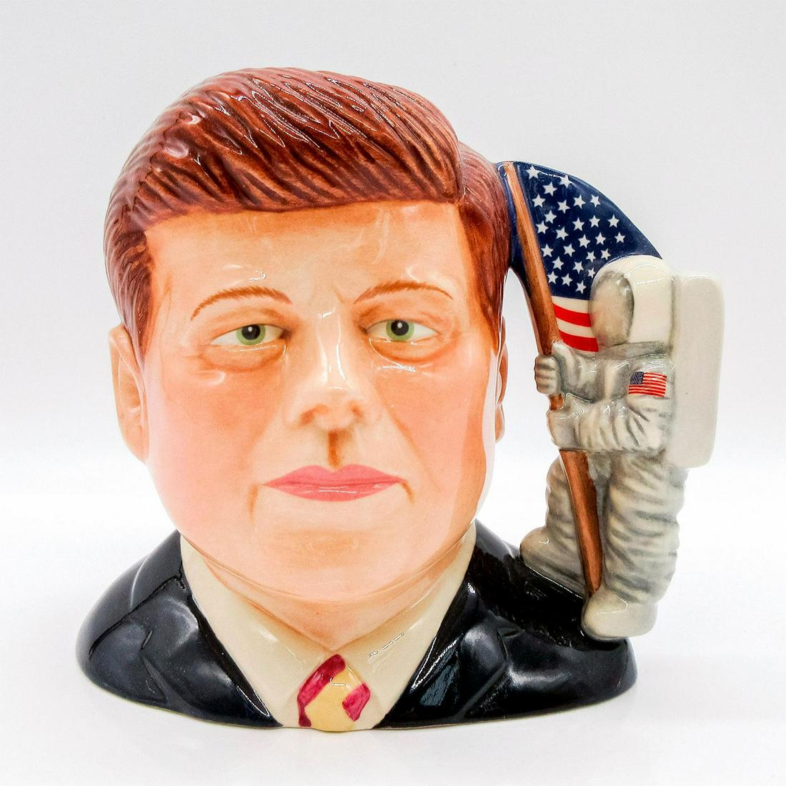 John F. Kennedy D7247 - Small - Royal Doulton Character Jug: Brown, dark blue, white, grey, and red. Limited edition number 58 of 250 pieces. Original box and certificate of authenticity included. Royal Doulton and Pascoe backstamp. Artist: Ray Noble Issued: 20