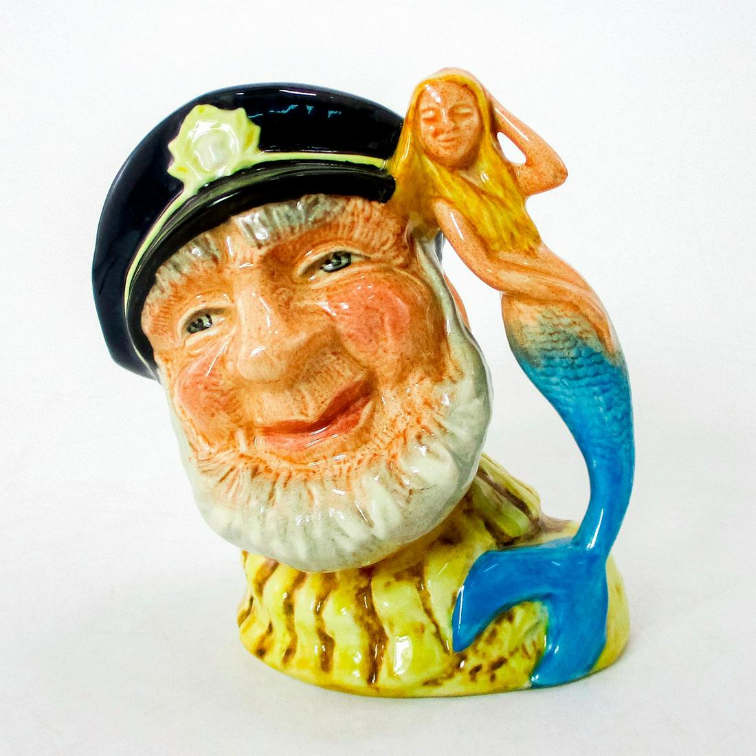 Old Salt D7153 (Colorway) - Small - Royal Doulton Character Jug: Variation Three. Mermaid has bright blue tail handle. Black cap with gold detail; cream fisherman's jersey. When the miniature Old Salt jug was launched in 1984, it had a hollow crook in the merma