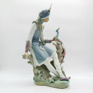 Arabian Knight 1001310 - Lladro Porcelain Figurine: Glossy finish; 15 inch tall figurine, a knight seated on tree trunk with a peacock. Lladro backstamp. Artist: Salvador Debon Issued: 1974-1981 Dimensions: 14.25"H x 10.5"W Manufacturer: Lladro