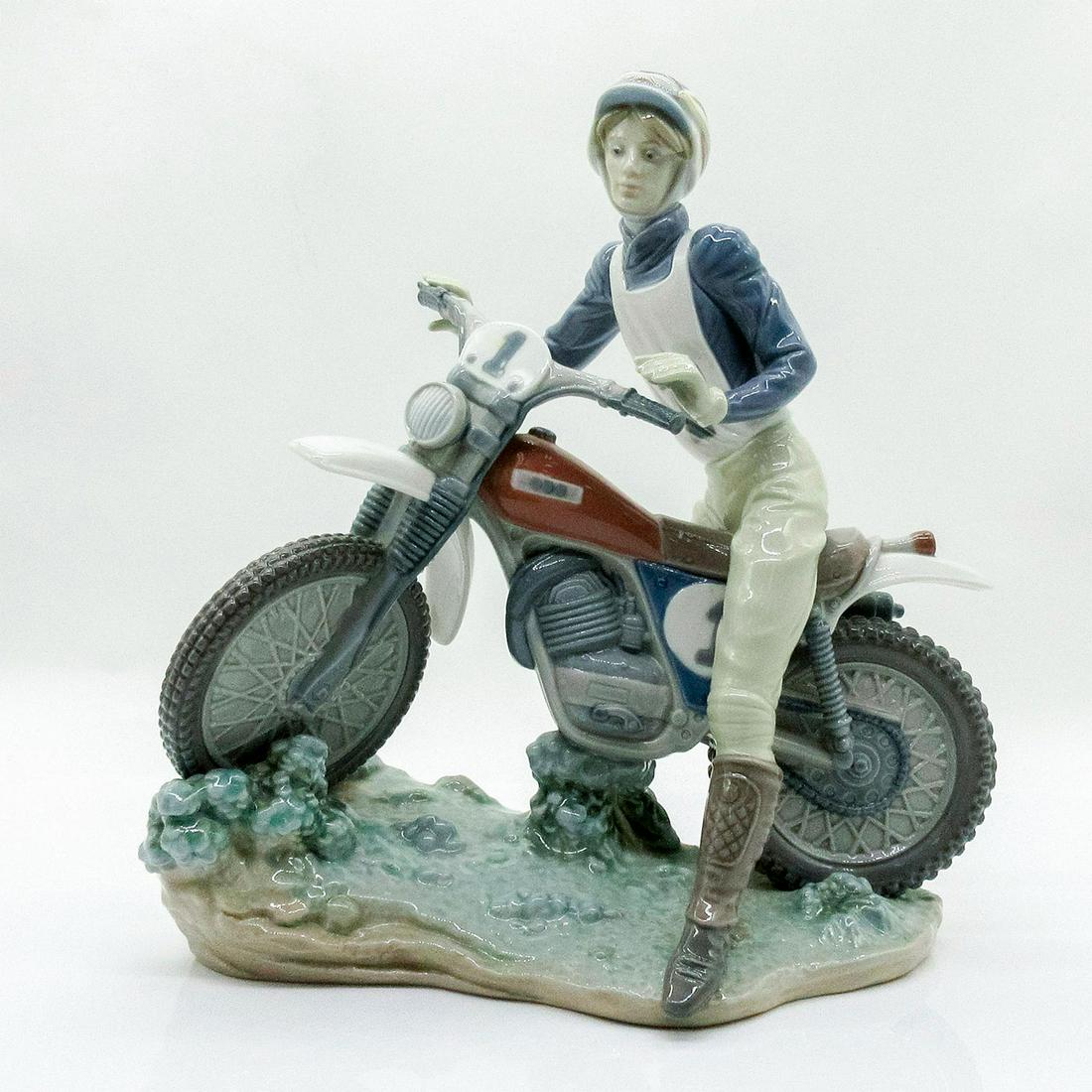 Racing Motorcyclist 1005270 - Lladro Porcelain Figurine: Glossy finish; Lladro backstamp on bottom. Artist: Jose Roig Issued: 1985-1987 Dimensions: 10.25"H Manufacturer: Lladro Country of Origin: Spain