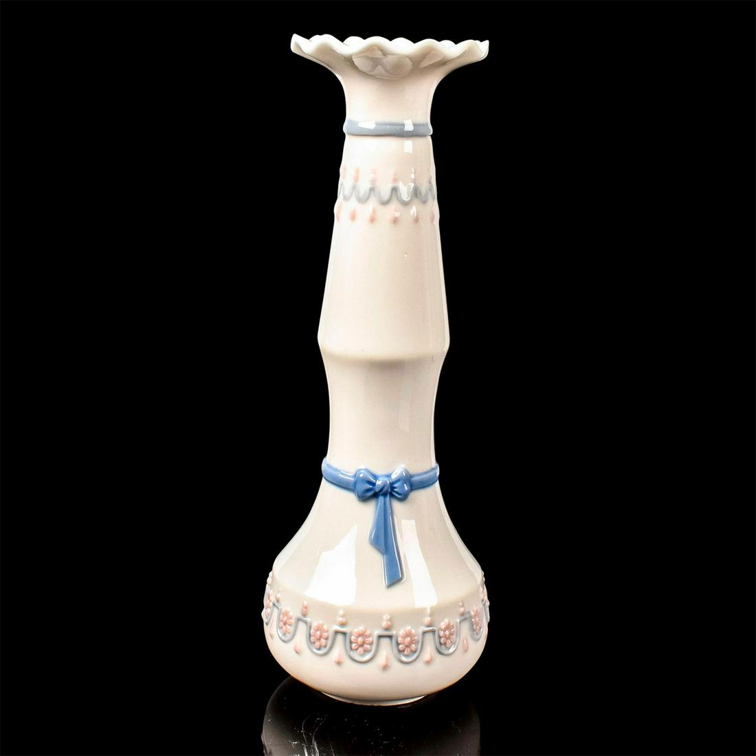 Candleholder 1005626 - Lladro Porcelain: Glossy finish, Lladro backstamp. Artist: Julio Ruiz Issued: 1989-1990 Dimensions: 7.25"H Manufacturer: Lladro Country of Origin: Spain