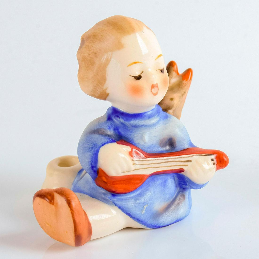 Angel with Lute 238/A - Goebel Hummel Figurine: Matte porcelain. Goebel backstamp. A small figure of an angel in blue playing a red lute. #GoebelHummel #AngelwithLute Dimensions: 2"H Manufacturer: Goebel Hummel Country of Origin: Germany