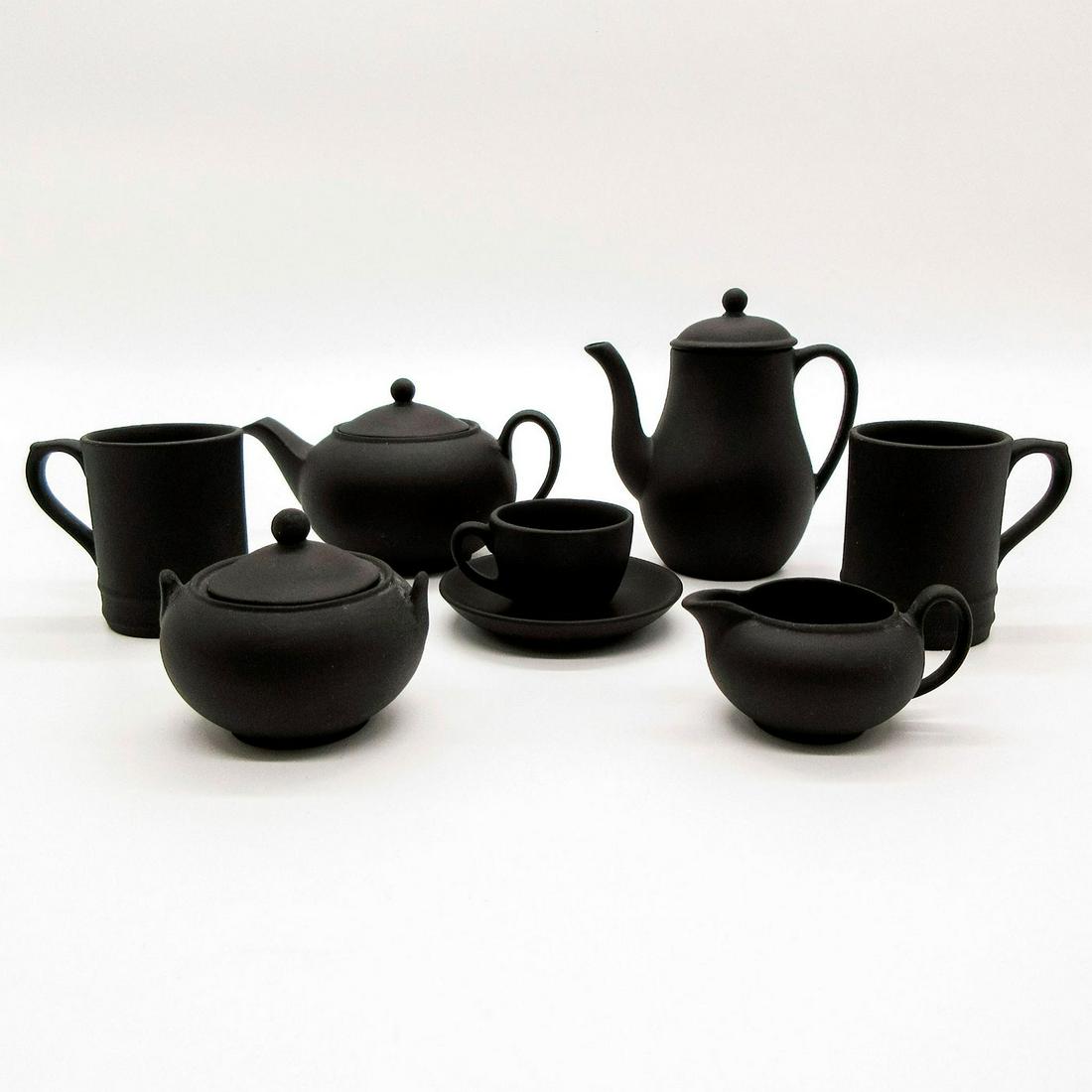 8pc Wedgwood Black Basalt Miniature Tea Ware: Black Basalt 6pc Tea wares and 2pc Tankards. Wedgwood impressed on back. This listing includes the following items; 2pc Tankards - 1.5"H. 1pc Cup - 0.75"H. 1pc Saucer - 2" Diameter. 1pc Cr